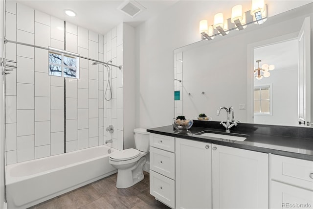 bathroom with visible vents, toilet, shower / tub combination, wood finished floors, and vanity