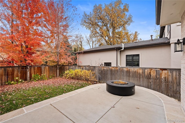 view of patio / terrace with a fenced backyard and a fire pit