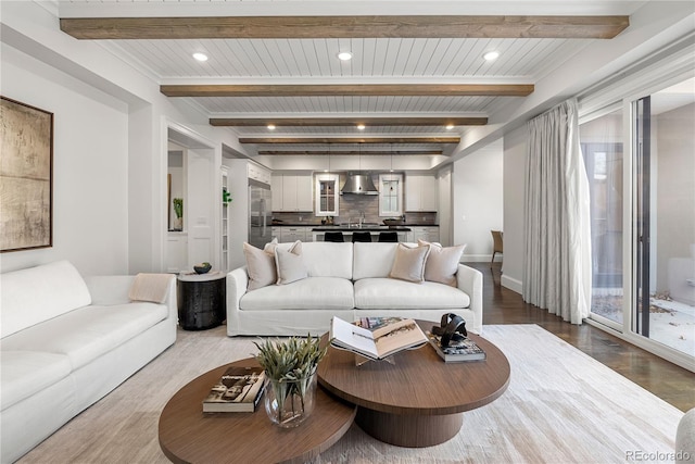 2218 S Clayton St, Denver, CO 80210 - living area featuring dark wood finished floors, beamed ceiling, baseboards, and recessed lighting
