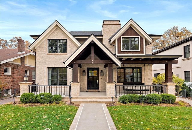2218 S Clayton St, Denver, CO 80210 - view of front of house with a porch, brick siding, and a chimney