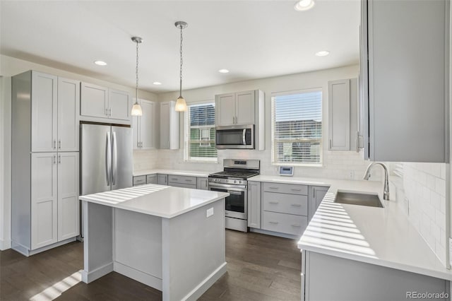 5668 Galena St, Denver, CO 80238 - kitchen featuring stainless steel appliances, backsplash, dark wood finished floors, a kitchen island, and recessed lighting