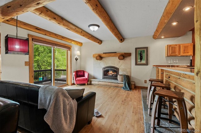 403 Pitkin St, Frisco, CO 80443 - living area with a warm lit fireplace, beam ceiling, recessed lighting, and light wood-type flooring