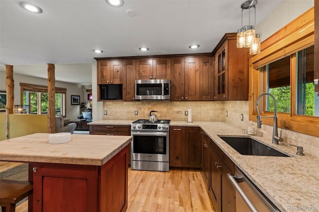 403 Pitkin St, Frisco, CO 80443 - kitchen featuring appliances with stainless steel finishes, recessed lighting, backsplash, light wood-style flooring, and light stone countertops
