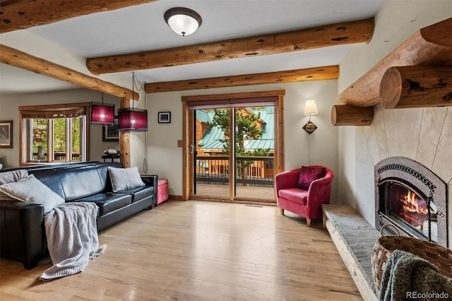 403 Pitkin St, Frisco, CO 80443 - living area featuring beam ceiling, wood finished floors, and a tile fireplace