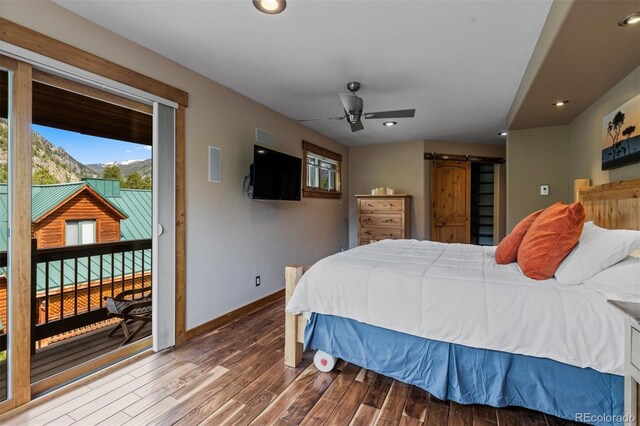 403 Pitkin St, Frisco, CO 80443 - bedroom with access to exterior, a barn door, wood finished floors, and recessed lighting