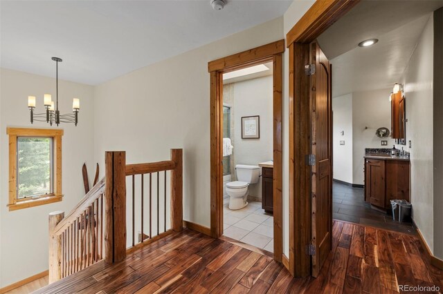 403 Pitkin St, Frisco, CO 80443 - hallway with an upstairs landing, a chandelier, and dark wood-style floors