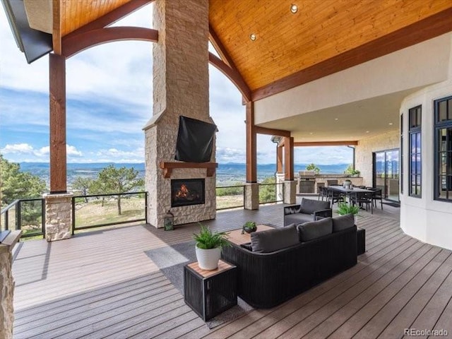 860 Diamond Ridge Cir, Castle Rock, CO 80108 - wooden terrace with outdoor dining space and an outdoor living space with a fireplace