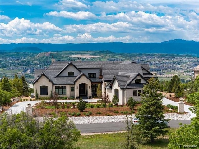 860 Diamond Ridge Cir, Castle Rock, CO 80108 - view of front facade featuring a mountain view, stucco siding, a chimney, and stone siding