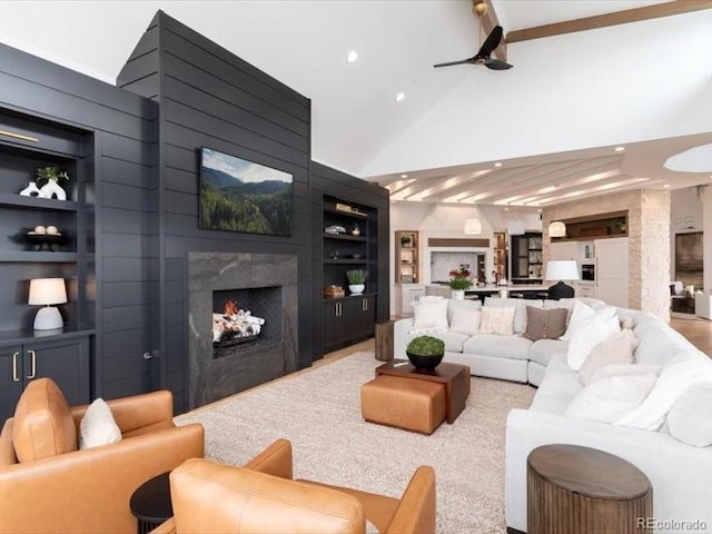 860 Diamond Ridge Cir, Castle Rock, CO 80108 - living area with built in shelves, a high end fireplace, recessed lighting, high vaulted ceiling, and a ceiling fan