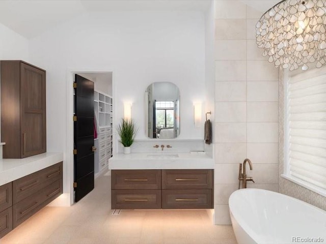 860 Diamond Ridge Cir, Castle Rock, CO 80108 - full bathroom with a soaking tub, vanity, and vaulted ceiling
