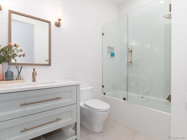 860 Diamond Ridge Cir, Castle Rock, CO 80108 - full bathroom featuring tile walls, toilet, vanity, shower / bath combination with glass door, and tasteful backsplash
