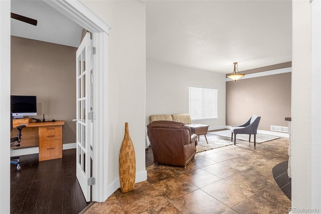 living area with visible vents and baseboards