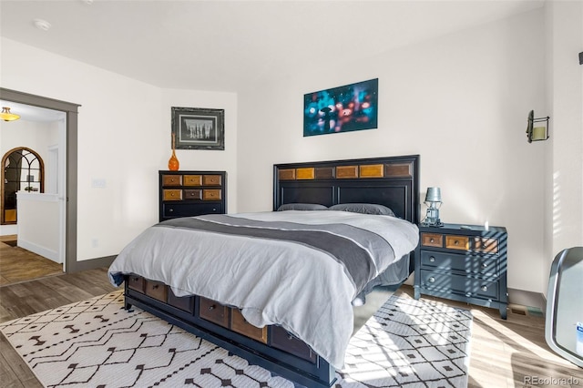 bedroom with baseboards and wood finished floors