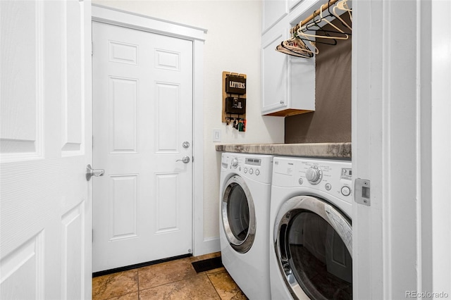 washroom featuring stone finish flooring, cabinet space, baseboards, and separate washer and dryer