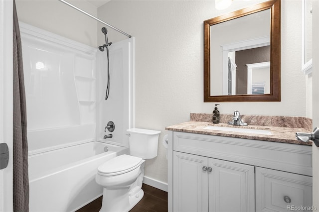 bathroom featuring shower / bathtub combination, toilet, vanity, wood finished floors, and baseboards