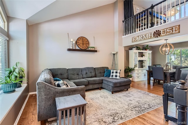 9492 Crestmore Way, Highlands Ranch, CO 80126 - living area with a chandelier, high vaulted ceiling, and wood finished floors