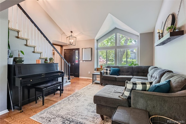 9492 Crestmore Way, Highlands Ranch, CO 80126 - living room featuring vaulted ceiling, stairs, light wood-type flooring, and a chandelier