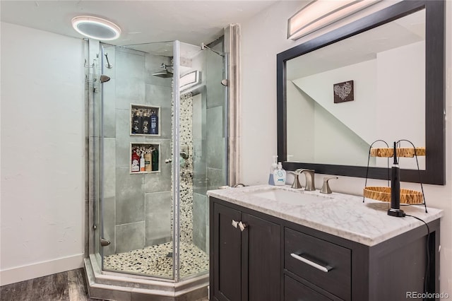 9492 Crestmore Way, Highlands Ranch, CO 80126 - full bath with wood finished floors, a shower stall, and vanity