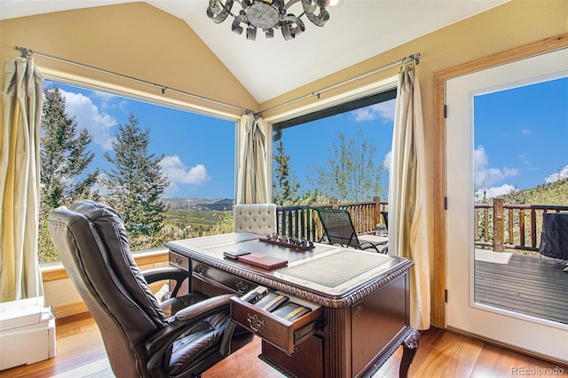 home office with vaulted ceiling and light hardwood / wood-style flooring