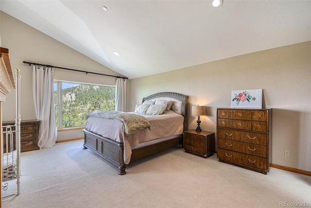 bedroom featuring lofted ceiling and light colored carpet