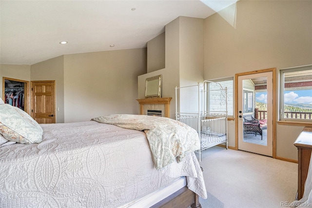 bedroom featuring light carpet, access to outside, a closet, and vaulted ceiling