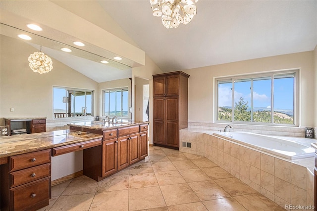 bathroom featuring lofted ceiling, tiled bath, vanity, and a notable chandelier