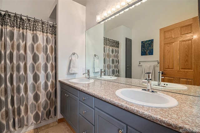 bathroom featuring tile patterned flooring and vanity