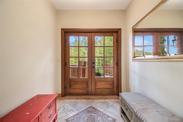 doorway featuring french doors and light tile patterned floors