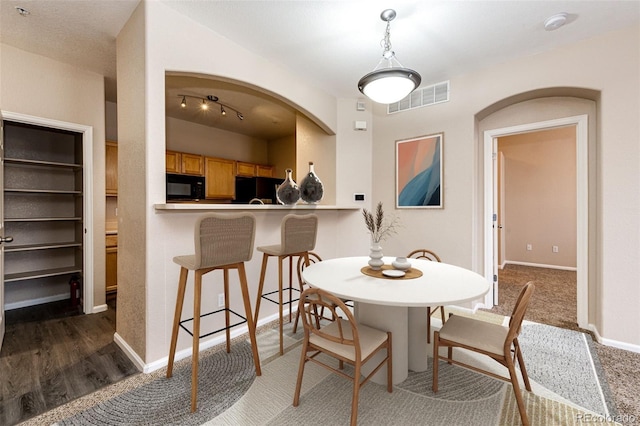 dining space with dark hardwood / wood-style flooring