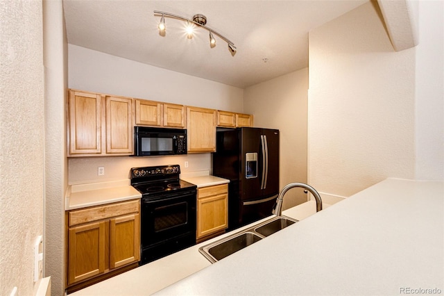 kitchen featuring sink, black appliances, and rail lighting