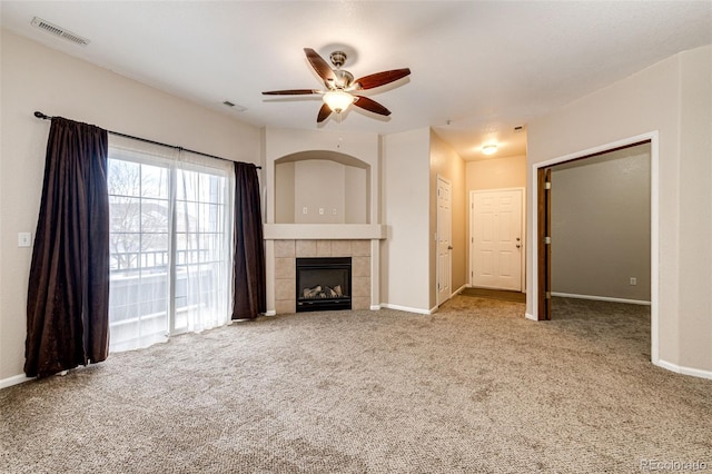 unfurnished living room with carpet floors, ceiling fan, and a fireplace