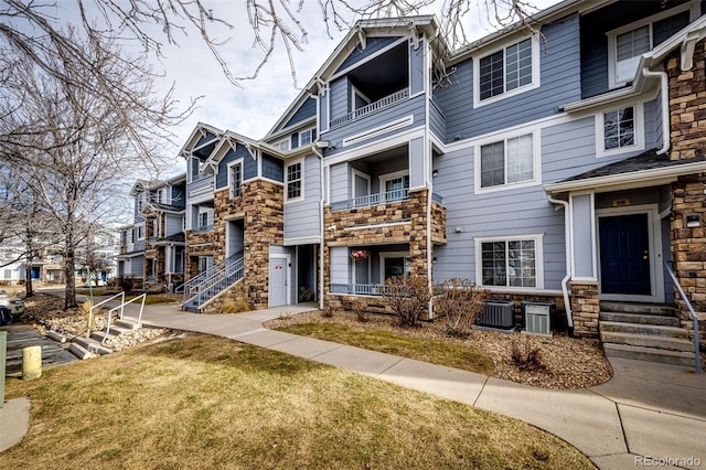 exterior space featuring a front yard and cooling unit