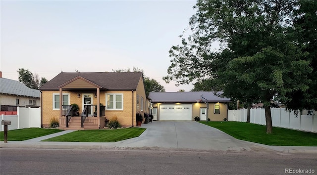 148 15th St, Burlington, CO 80807 - view of front facade with a garage, concrete driveway, and brick siding