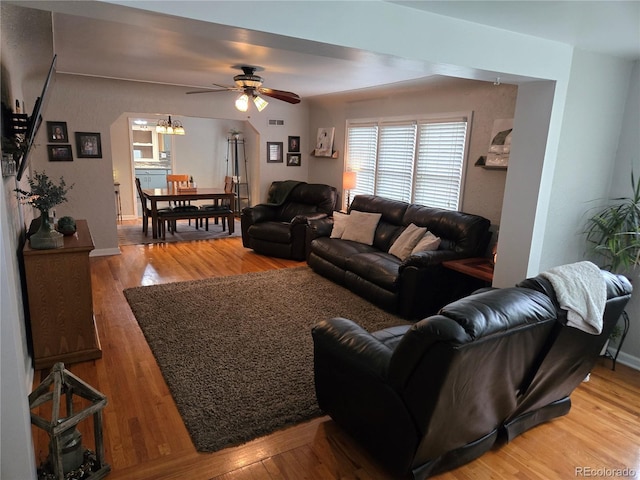 148 15th St, Burlington, CO 80807 - living room with a ceiling fan, light wood-type flooring, and a chandelier