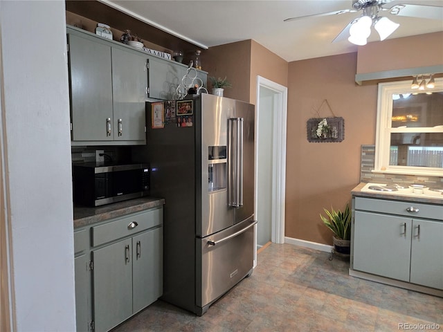 148 15th St, Burlington, CO 80807 - kitchen with appliances with stainless steel finishes, gray cabinets, ceiling fan, and stone finish flooring