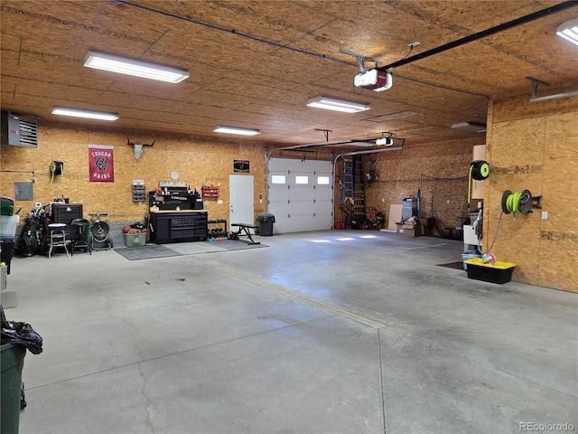 148 15th St, Burlington, CO 80807 - garage featuring a garage door opener and a workshop area