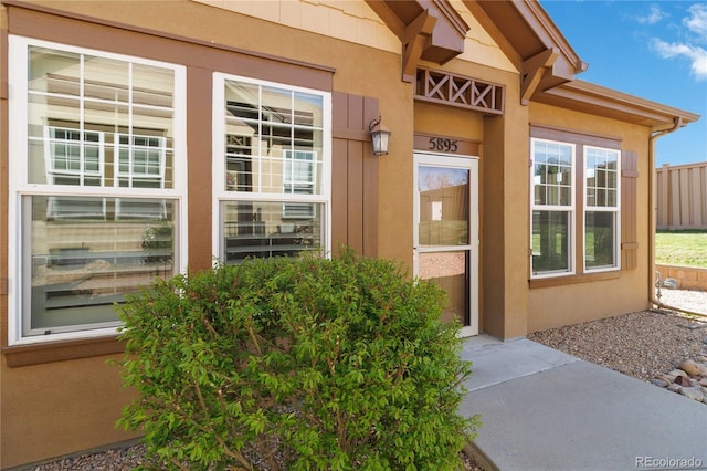 5895 S Taft Ct Unit H, Littleton, CO 80127 - doorway to property featuring stucco siding and fence