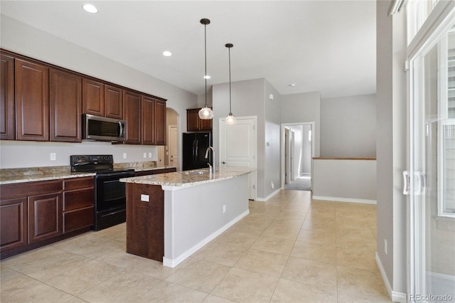 5895 S Taft Ct Unit H, Littleton, CO 80127 - kitchen with black appliances, arched walkways, light stone counters, an island with sink, and hanging light fixtures