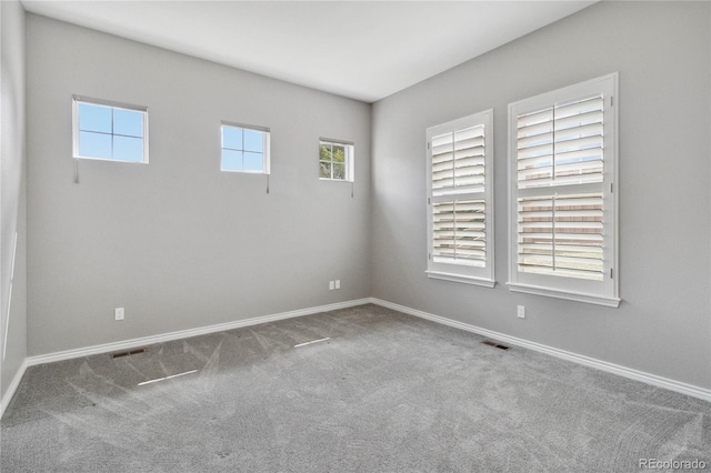 5895 S Taft Ct Unit H, Littleton, CO 80127 - unfurnished room featuring plenty of natural light, carpet, and baseboards