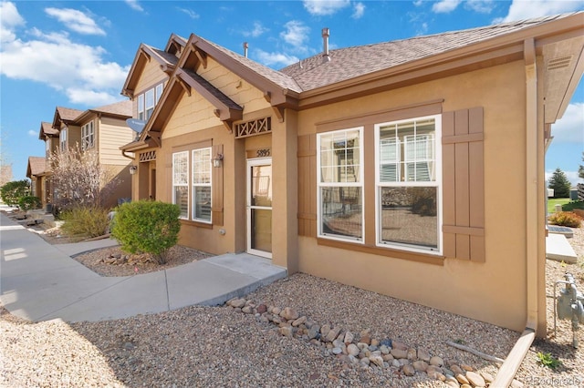 5895 S Taft Ct Unit H, Littleton, CO 80127 - property entrance featuring stucco siding and a shingled roof