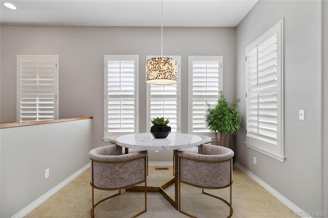 5895 S Taft Ct Unit H, Littleton, CO 80127 - dining space with healthy amount of natural light, baseboards, and light tile patterned floors