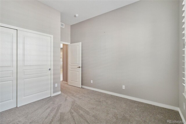 5895 S Taft Ct Unit H, Littleton, CO 80127 - unfurnished bedroom featuring carpet, a closet, and baseboards