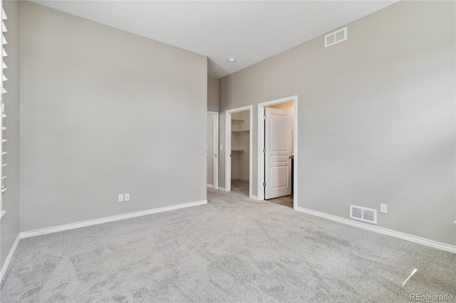 5895 S Taft Ct Unit H, Littleton, CO 80127 - unfurnished bedroom featuring carpet, a spacious closet, and baseboards