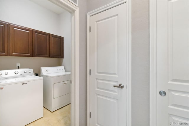 5895 S Taft Ct Unit H, Littleton, CO 80127 - laundry room with cabinet space, washing machine and dryer, and light tile patterned floors