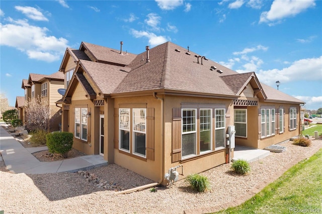 5895 S Taft Ct Unit H, Littleton, CO 80127 - rear view of house with a shingled roof, stucco siding, and a patio