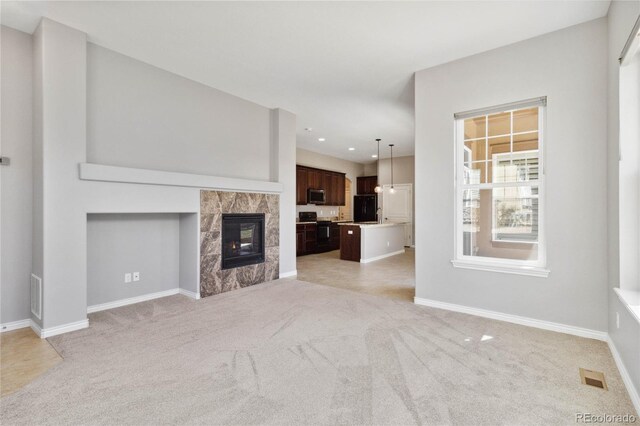 5895 S Taft Ct Unit H, Littleton, CO 80127 - unfurnished living room with light carpet, baseboards, recessed lighting, and a fireplace