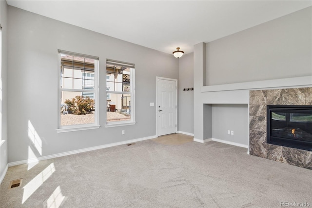5895 S Taft Ct Unit H, Littleton, CO 80127 - unfurnished living room featuring carpet flooring, a fireplace, and baseboards