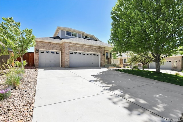 20394 E Colgate Pl, Aurora, CO 80013 - view of front of home with an attached garage, concrete driveway, and brick siding