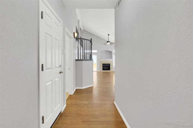20394 E Colgate Pl, Aurora, CO 80013 - corridor with lofted ceiling, wood finished floors, baseboards, and a textured wall