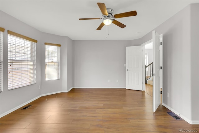 20394 E Colgate Pl, Aurora, CO 80013 - unfurnished room featuring a ceiling fan, wood finished floors, baseboards, and stairway